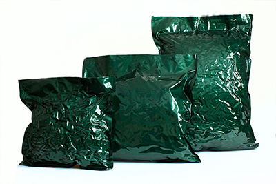 Different sized custom laminated green flexible film bags filled